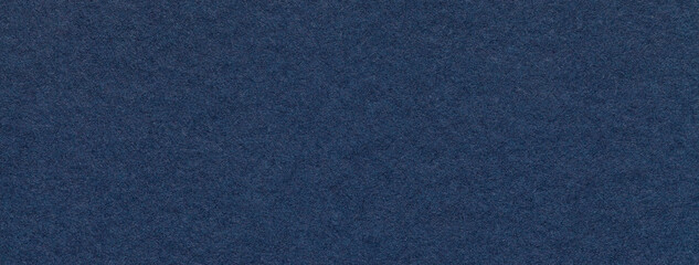 Texture of craft navy blue paper background colors, macro. Structure of vintage kraft denim...