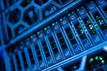 close up of network cables connected to server racks in data center room.