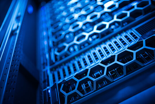 close up of network cables connected to server racks in data center room.