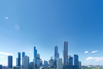 Obraz premium Drone View of City Office Buildings Beneath Blue Skies and White Clouds