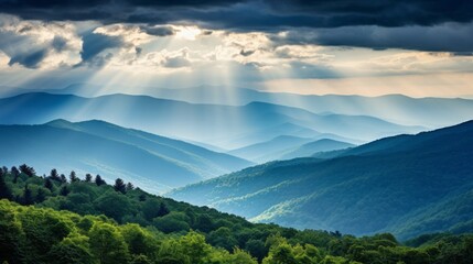 Obraz premium the morning sun shines through the clouds on the mountains of the valley and the forest in the fog.