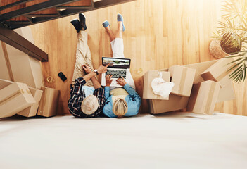Laptop, moving and couple with boxes in new home online shopping for furniture from above....