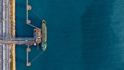 Aerial view oil tanker ship oil depot terminal storage petroleum petrochemical refinery product, Global Business energy tanker ship logistic transportation oil industry crude oil fuel by tanker ship.