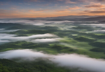 This stunning aerial view captures the ethereal beauty of a mist-laden valley. Rolling hills cloaked in lush greenery stretch out beneath a sky painted with dramatic clouds. The soft mist weaves throu