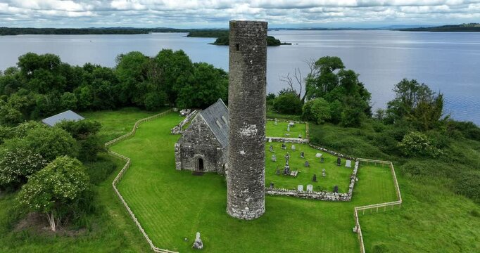Ireland Epic Locations drone circling right church and round tower at important early Christian site Holy Island Lough Derg on The Shannon River