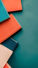 Fototapeta premium Assortment of Colorful Books on a Solid Teal Background