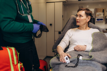 A woman's blood sugar is measured in an ambulance