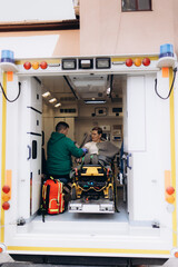 A woman being examined in an ambulance