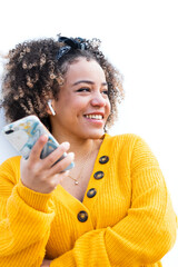 Smiling African American girl walking in university park using mobile phone shopping online or...