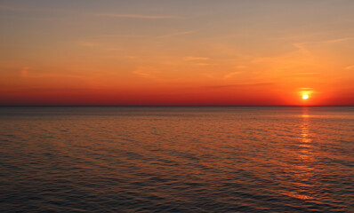 a beautiful sunset at sea on the island of Aruba generated with artificial intelligence