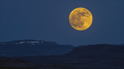 Bright yellow moon shining in the night sky above the Arctic tundra in late summer