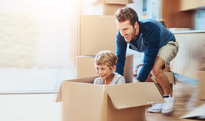 New home, dad or child in box for play, game or car fantasy in living room. Happy boy, father and break from moving for support, property investment or real estate opportunity for family house