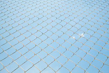 metal fence wire net on blue sky background