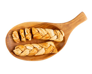 Braided dried melon. Dried melon in form of pigtail on wooden plate isolated on white background. Natural sweet dessert. Top view.