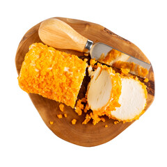 Buche de Chevre. Soft goat cheese topped with dried mango on wooden board isolated on white background. Top view.