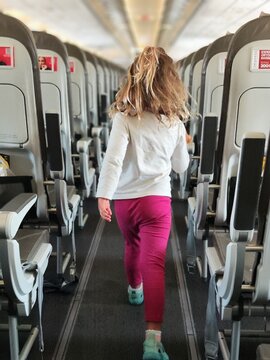 "Curious Toddler Exploring Economy Row: A Journey Inside the Plane with the Flight Crew"