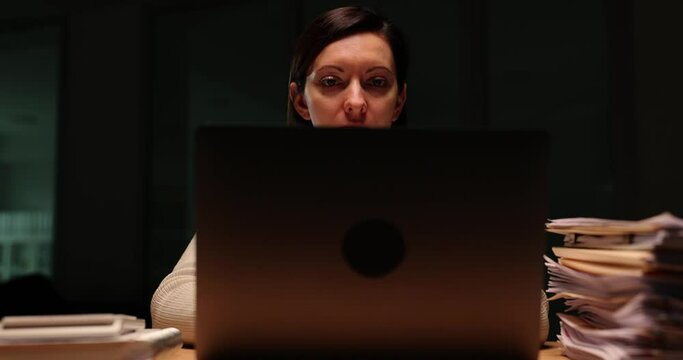 Woman company worker closes laptop ending work day in office