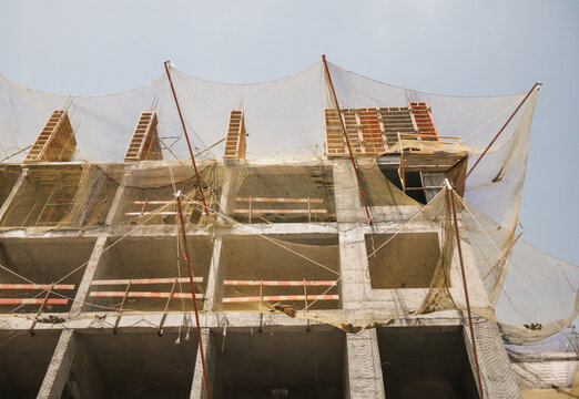Construction site with safety net on each floor, building architecture development