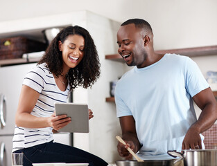 House, kitchen and couple with tablet for cooking, recipe website and instructions of food dish. Interracial marriage, man cook and woman with digital for online ingredients, browse and laugh in home