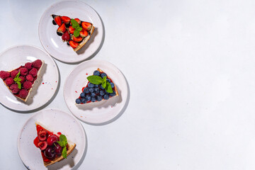 Summer cheesecake slices with various berry