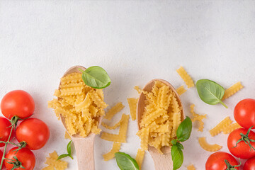 Raw Mafaldine pasta with ingredient for cooking