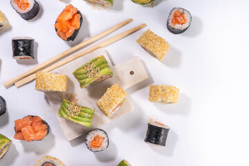 Creative sushi set background containing sushi rolls, maki, gunkan
