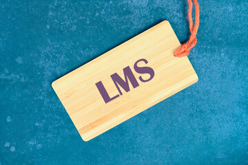 LMS - Learning Management System acronym. LMS on a card with a string