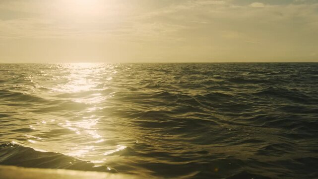 Serene early morning scene of sunlight glistening on ocean water