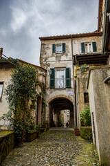 A glimpse of the ancient medieval village of Sorano, on a melancholy and rainy spring day. In the province of Grosseto, Tuscany, Italy. The old houses built in stone and tuff bricks.