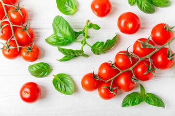 Fresh cherry tomatoes and fresh green basil on a textured background. Tomato sauce. Vegan. Ingredients for salad. Organic food. Place for text. Copy space.
