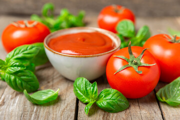 Fresh cherry tomatoes and fresh green basil on a textured background. Tomato sauce. Vegan. Ingredients for salad. Organic food. Place for text. Copy space.