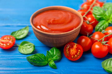 Fresh cherry tomatoes and fresh green basil on a textured background. Tomato sauce. Vegan. Ingredients for salad. Organic food. Place for text. Copy space.