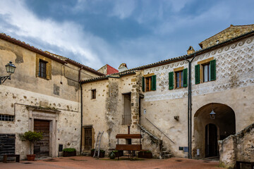 A glimpse of the ancient medieval village of Sorano, on a melancholy and rainy spring day. In the province of Grosseto, Tuscany, Italy. The old houses built in stone and tuff bricks.