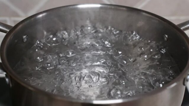 Water boiling. Close-up in pot of boiling water. Bubbles of boiling water.