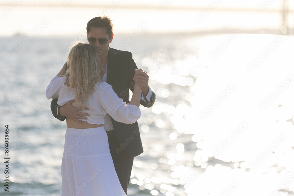 Wall mural Couple Dancing at Sunset by the Sea