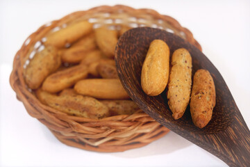 Fresh baked homemade grissini breadsticks in the basket on kitchen counter top. Bakery galette