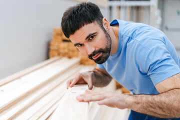 Young man with a beard in casual clothes in a construction hypermarket