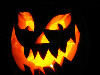 Jack-o'-lantern pumpkin for Halloween. Menacing carved pumpkin glowing in the dark. Ideal for Halloween poster party