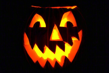 Jack-o'-lantern pumpkin for Halloween. Menacing carved pumpkin glowing in the dark. Ideal for Halloween poster party