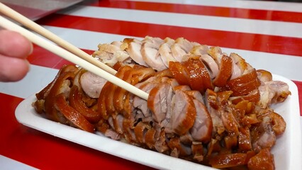 Succulent pork legs, simmered in a special broth, are presented cut into portions.