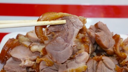 Succulent pork legs, simmered in a special broth, are presented cut into portions.