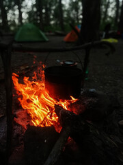 Hot Camping Fire Flame in mountains at twilight