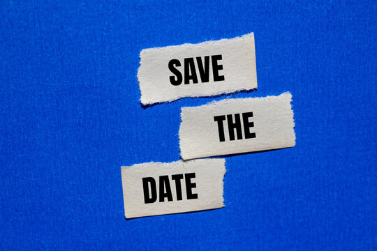 Save the date words written on ripped torn paper pieces with blue background. Conceptual save the date symbol. Copy space.