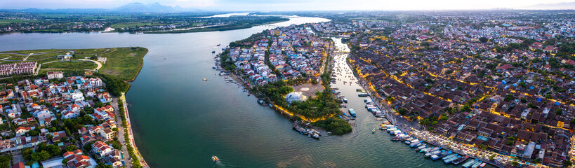 Fototapeta premium Aerial view of Hoi An Ancient Town with lantern boats on Hoai river, in Hoi An, Vietnam