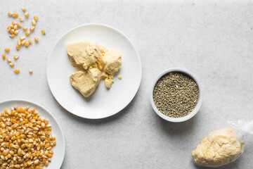 Overhead view of corn millet and nigerian akamu or pap, process of making akamu, flatlay of process of making nigerian akamu ogi pap or corn pudding