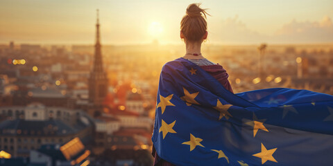Person draped in the European Union flag overlooking a cityscape