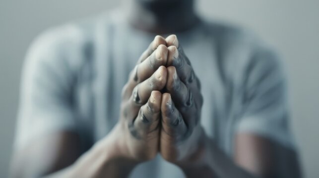 People's hands clasped together in prayer. fingers interlocked and gently press the palm Quiet moments reflect deep spirituality and inner peace. It reflects a powerful expression of faith and respect