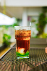A glass of fresh drink on a table outdoors