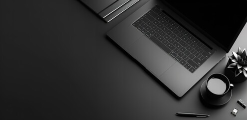 A black laptop, a cup of coffee and a decorative plant are on a black office table