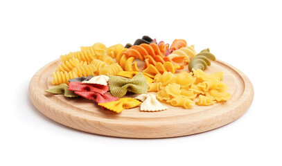 Wooden board with different kinds of uncooked pasta on white background